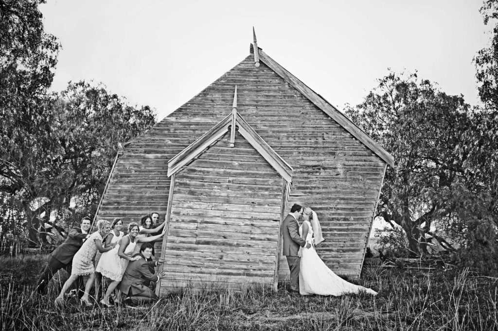 when an old church is leaning as bride and groom kiss as the bridal party try to knock them over tangarratta