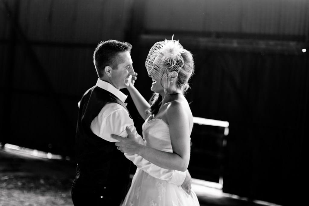 smiles and giggle and a dance for a bride and groom as they dance in an old shed at Roma QLD