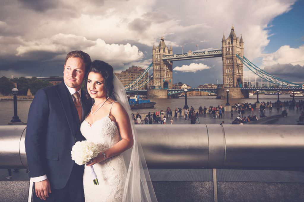 a bride a groom and a super model light at london bridge