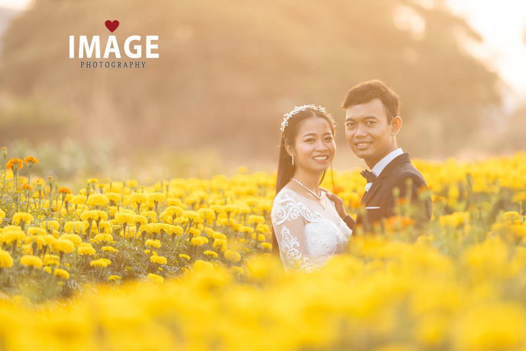 smiels as the sun sets on the outskirts of phnom penh for a pre-wedding shoot