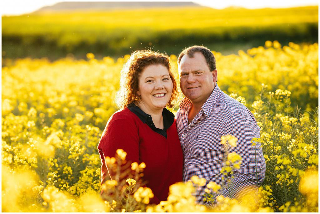 a sea of yellow in a canola field near Tamworth a couple hold each other tight