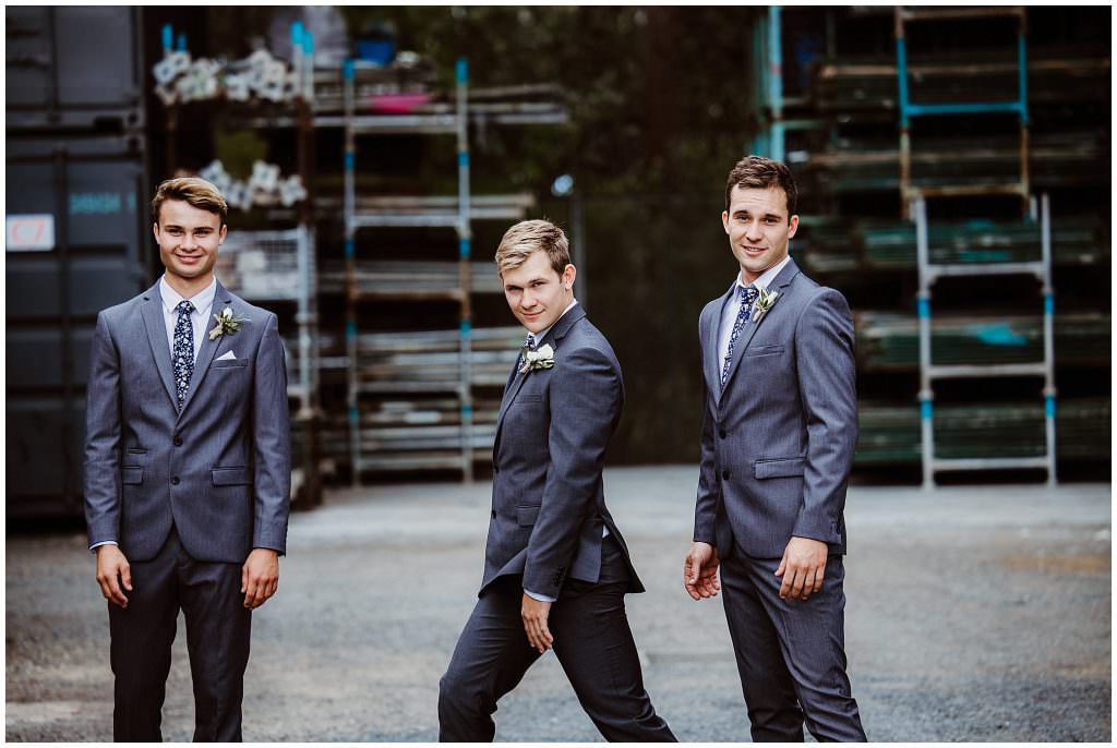 male model for your wedding day a groomsmen in a grey suit pose it up amongst metal