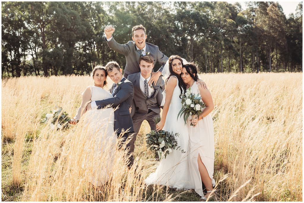 fun poses of a bridal party of six near Seal Rocks