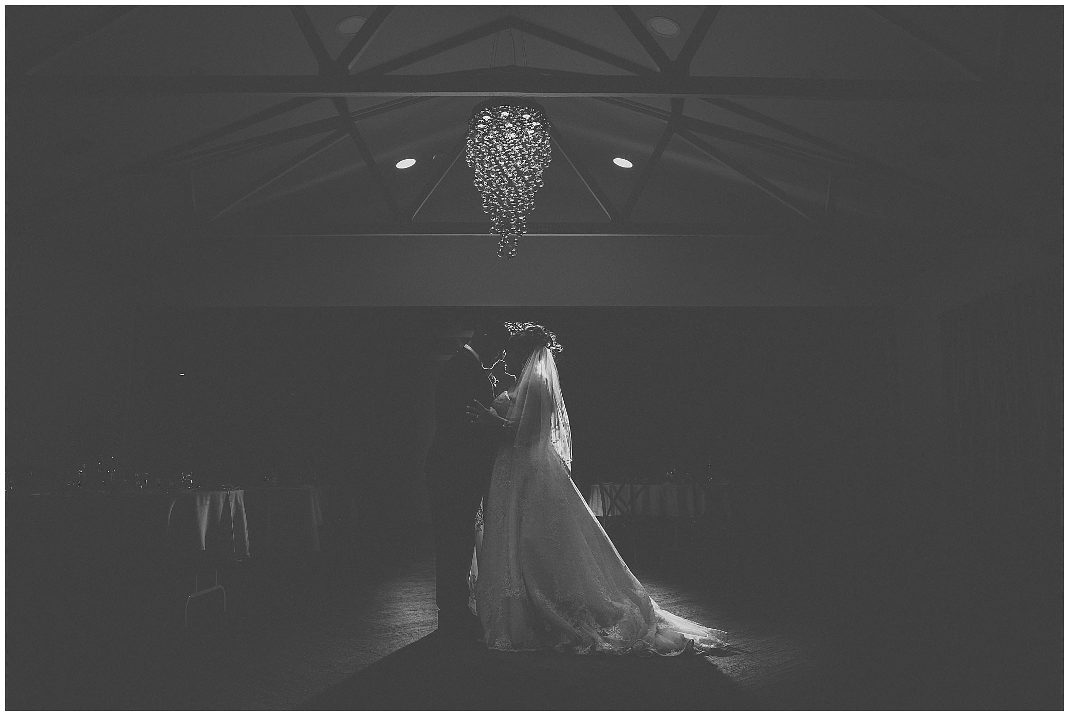 a bride and groom lit up by a chandelier at Corey's function centre