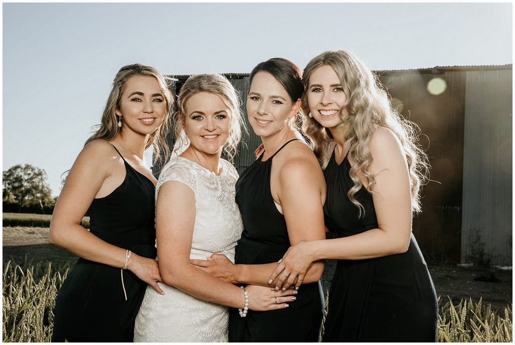 bridemaids with the sun setting in their hair smil