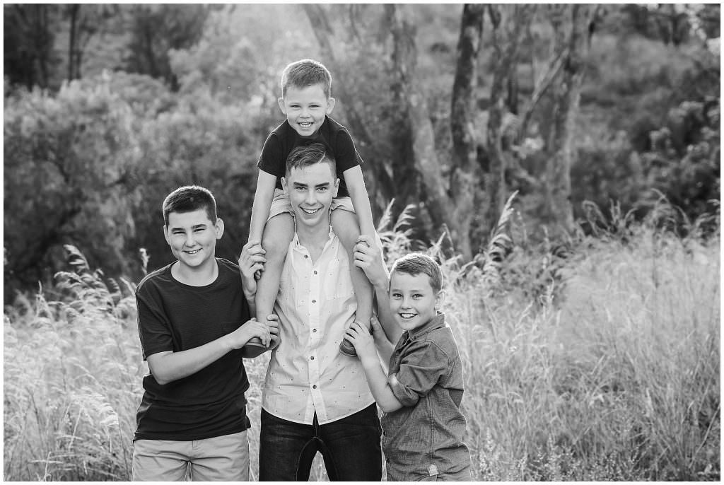 black and white photo...of four gunnedah boys with the youngest on his shoulder