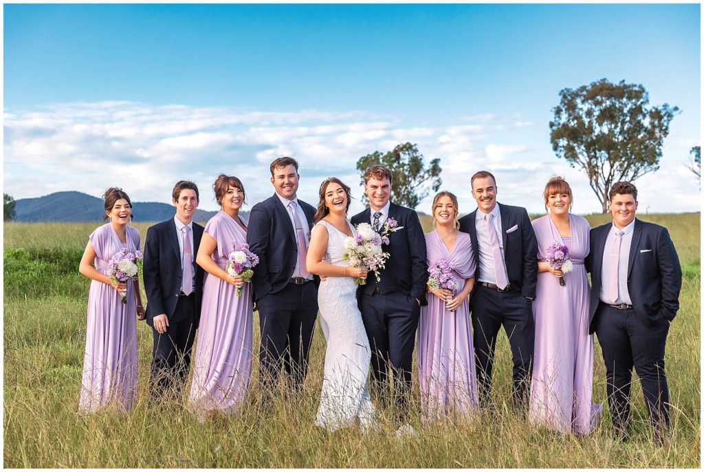 laughs blue sky as a couple hangout with their bridal party at moore creek NSW