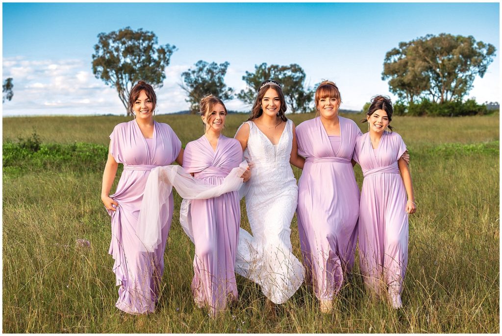 the bride tribe walk in long grass at Moore creek, Tamworth