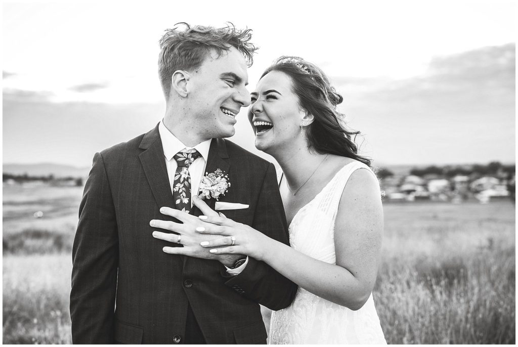 natural laughs at a wedding for this couple and their wedding photos as they hold onto each other