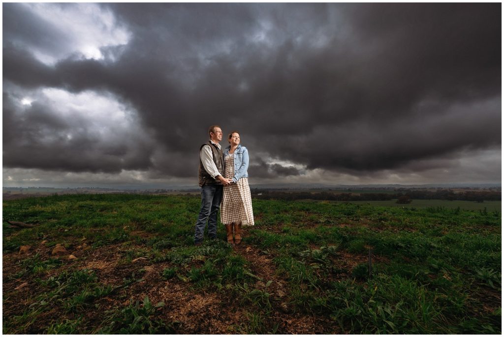 storm clouds cowra hills a couple hold onto each other