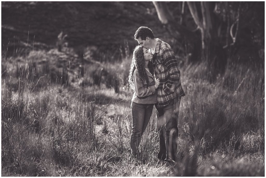 a kiss on the forehead for a couple in the aussie bush