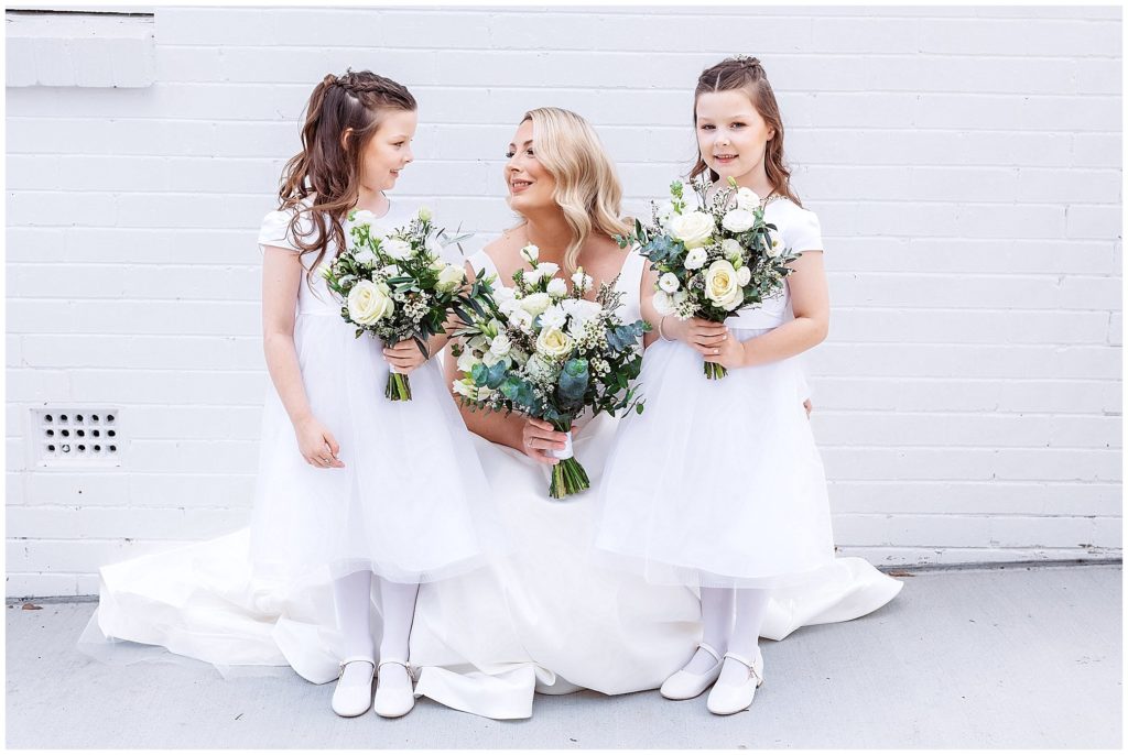 flowers by designer bunches tamworth a bride in white holds her flowers as does her twin flower girls