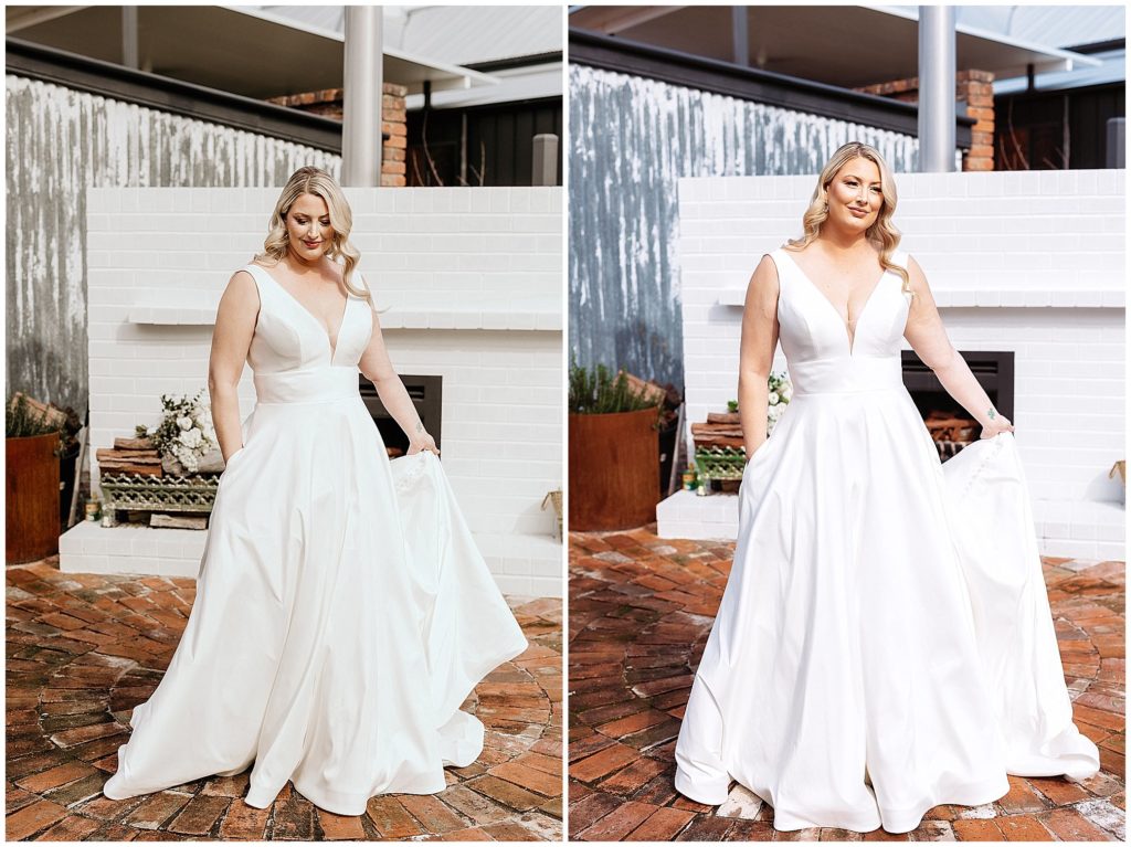 a bride with a white dress with pockets holds her dress with an outdoor fore place in the background at Querencia airnbn East Tamworth NSW