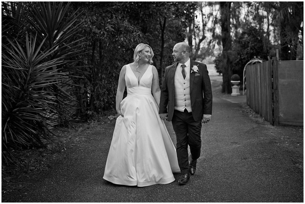 walking on a road out the back of the pavillion a couple look at each other