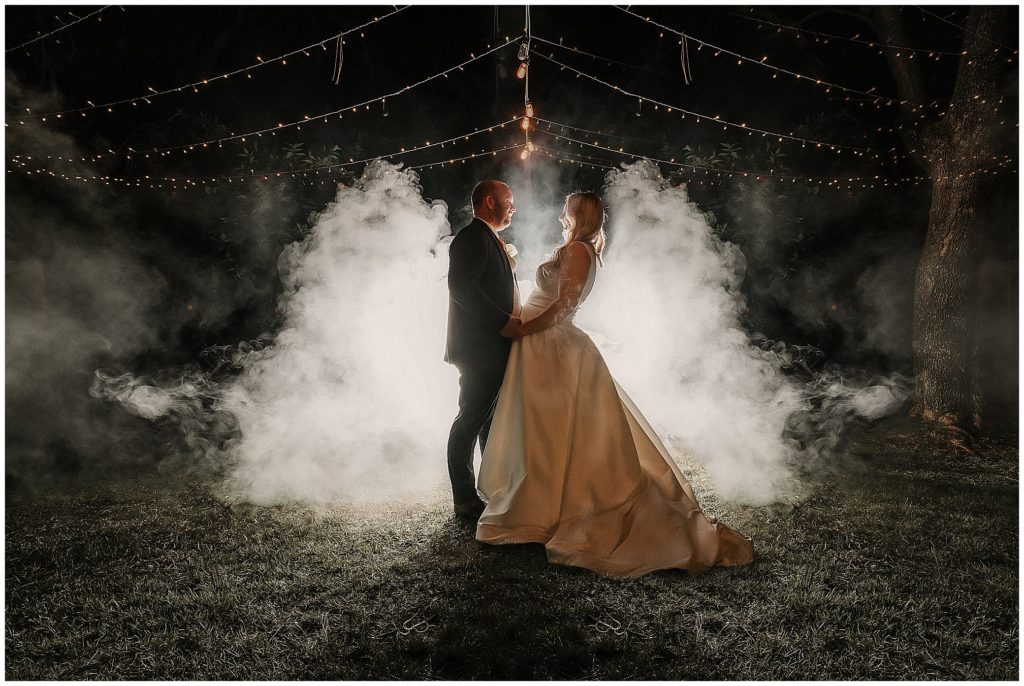 fairy lights and smoke for a bride and groom at their reception in the gardens at the Pavillion function centre Tamworth