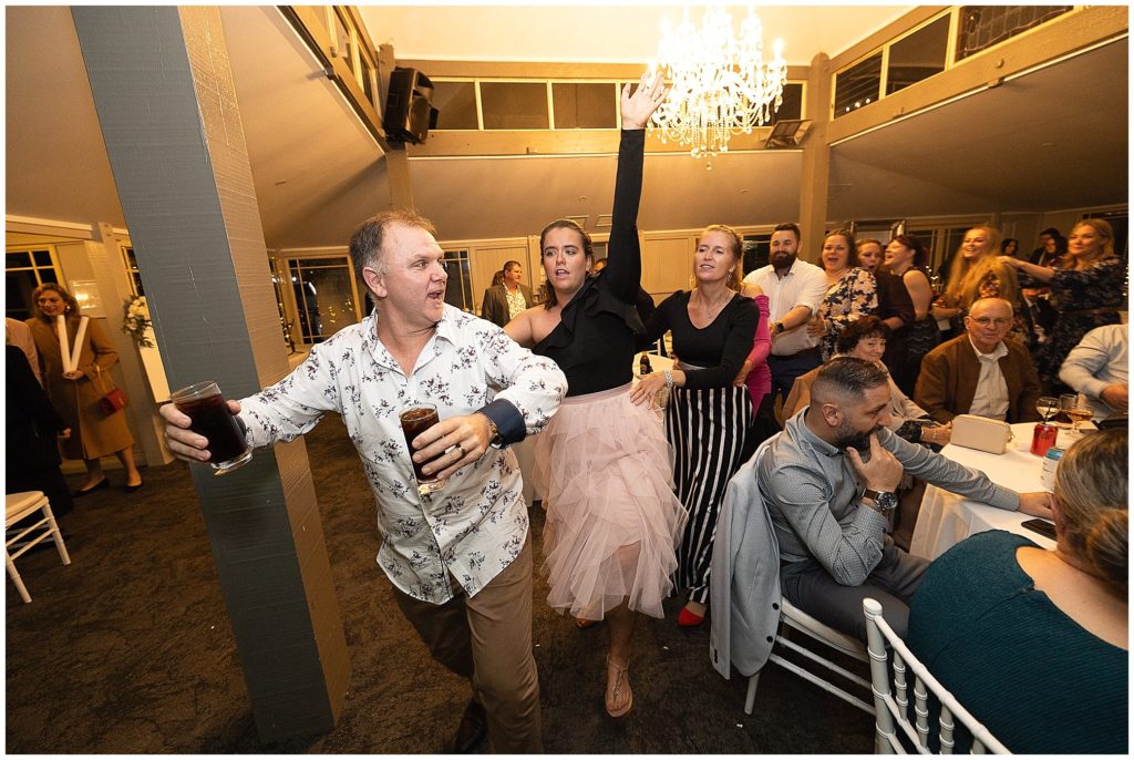 congo line at a wedding reception at The Pavillion function centre Tamworth as a guests holds two drinks