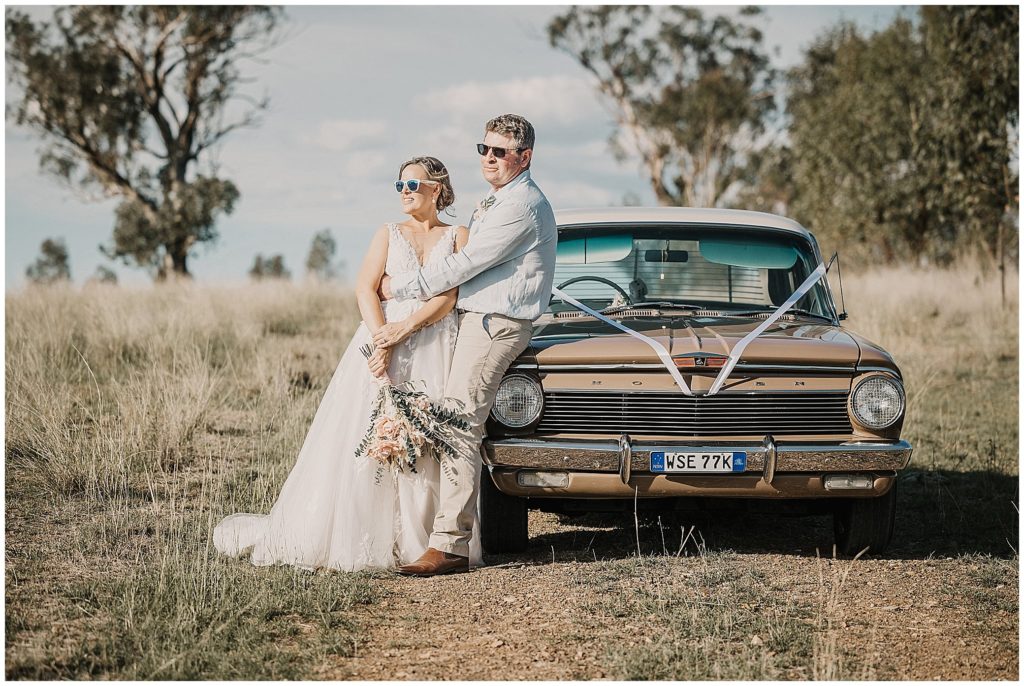 a vintage car in tamworth country weddinf a bride with sunnies