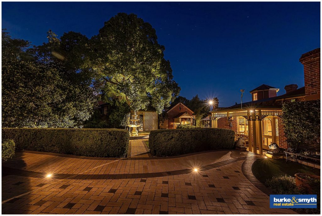 in the garden & paved aread with a water fountain at night a shot is taken in Tamworth nsw of a house for sale by Burke & Smyth real estate
