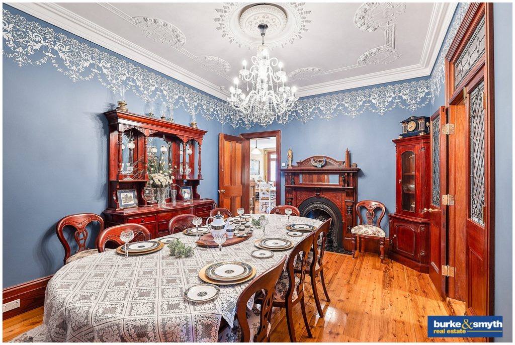 inside a a dining room with a crystal chandelier blue walls in an old house in Tamworth NSW