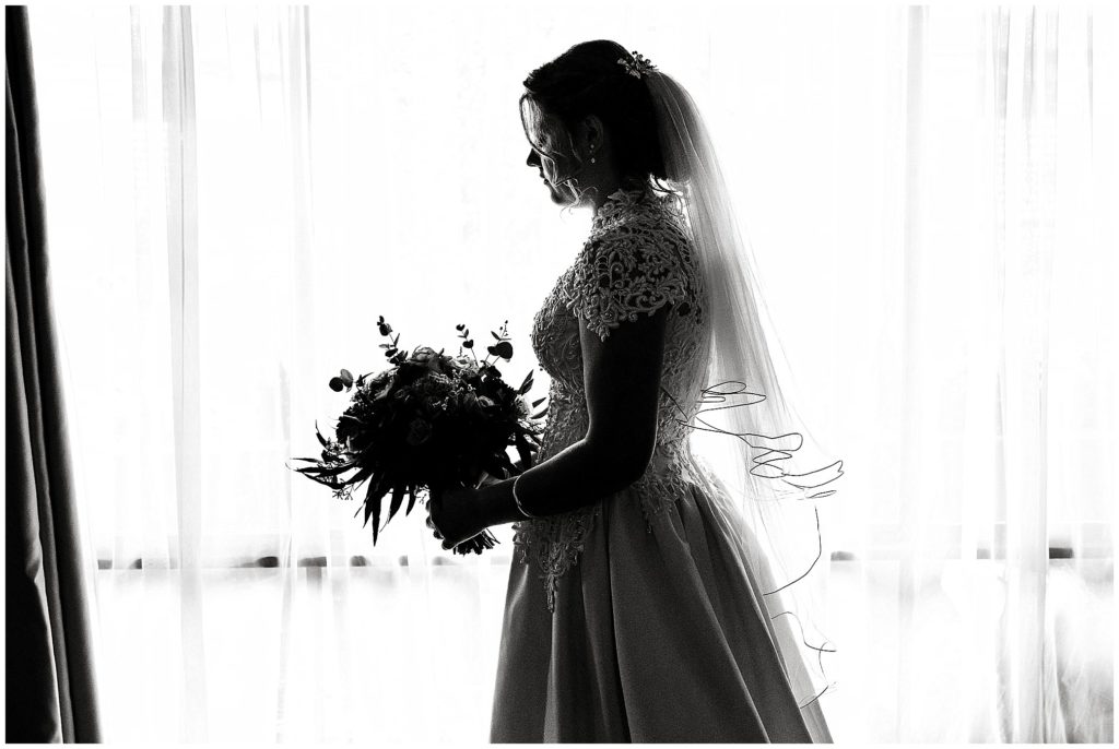 black and white of a bride in front of a window on her wedding day Uralla NSW
