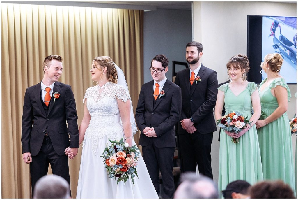 a couple look at each in their ceremony and smile