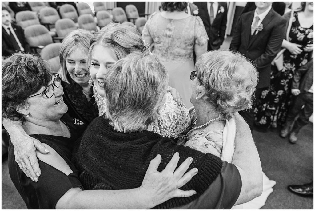 all the nannas hug the bride