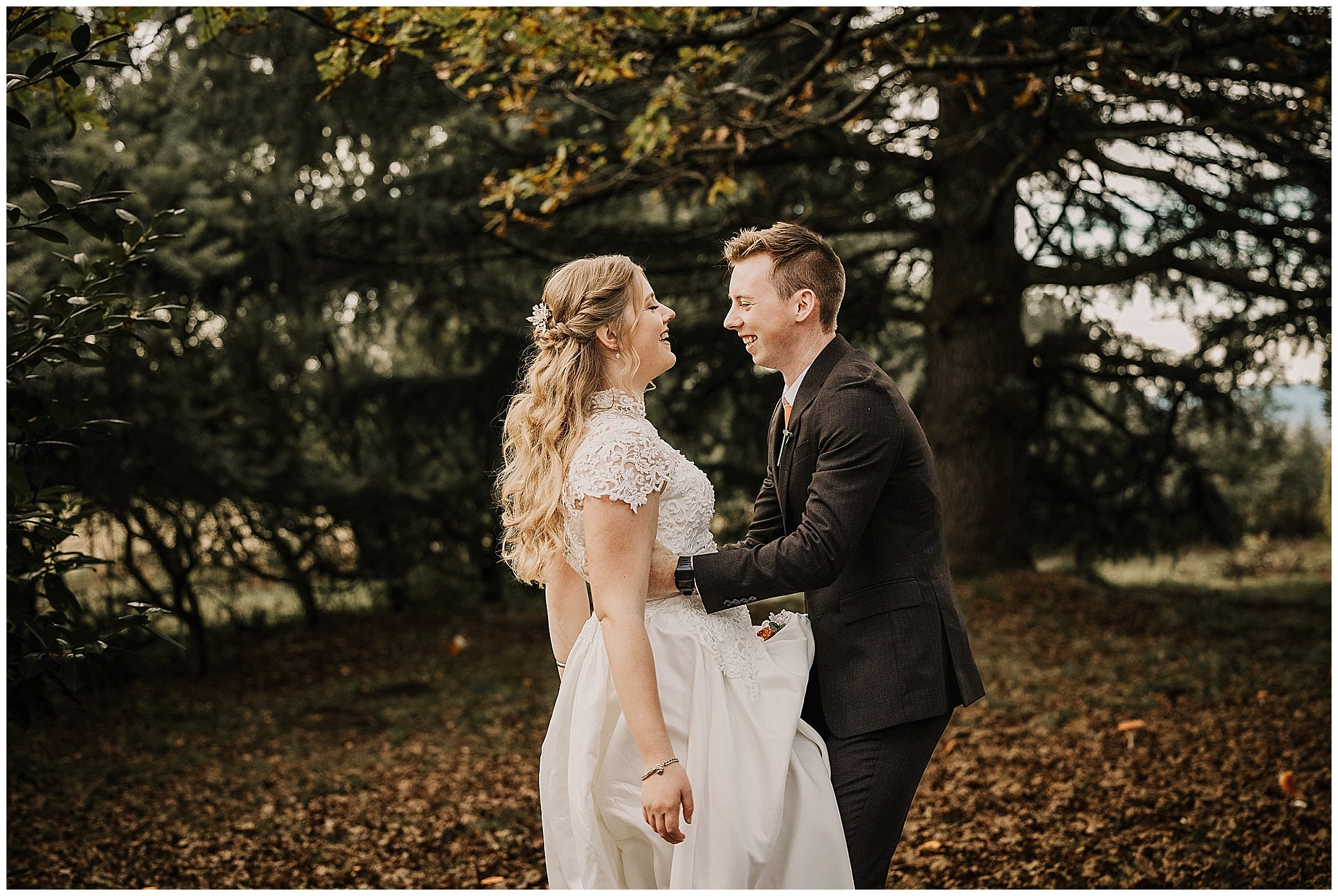 under a big oak tree at rock abbey gardens Uralla a groom and bride laugh as he holds her