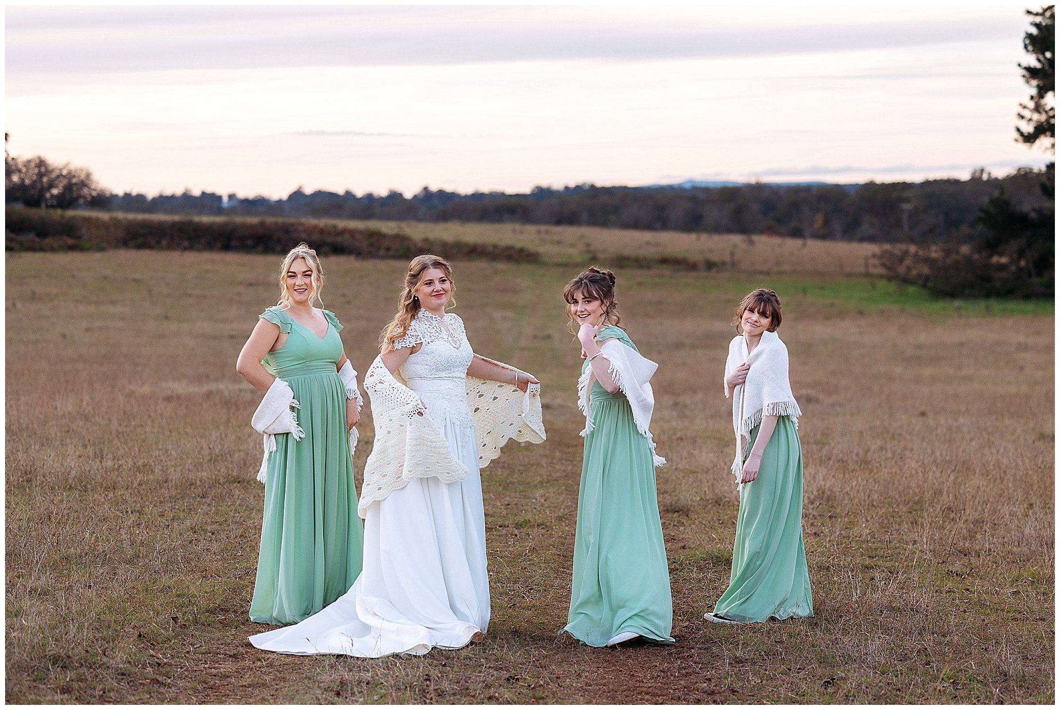 girls in mint dresses at a wedding in a paddock