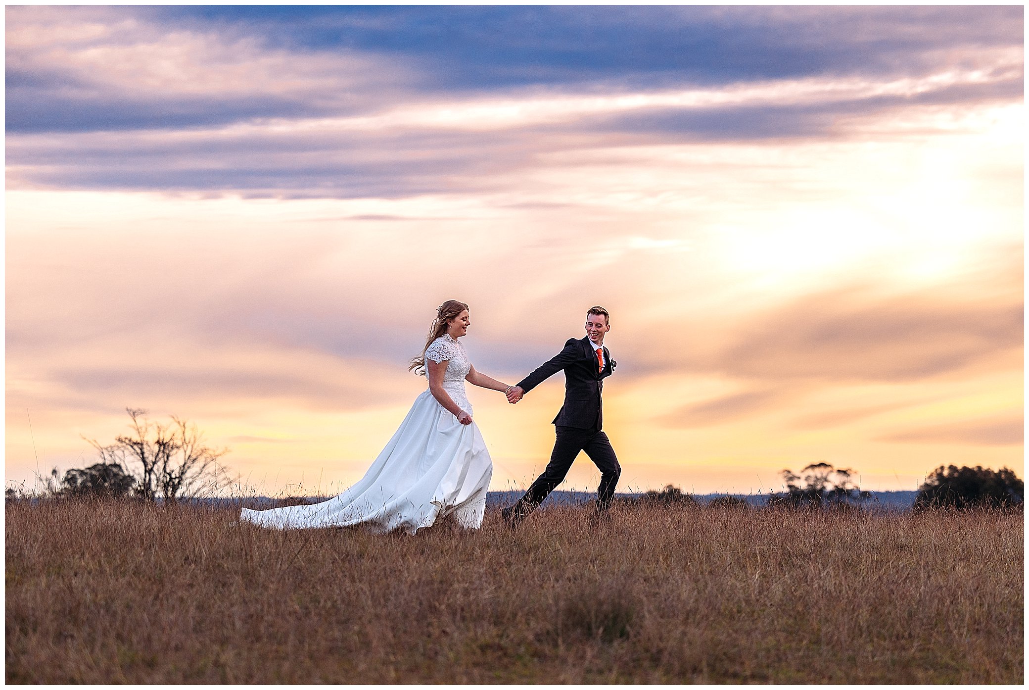 runaway bride and groom as an amazing sunset at rock abbey gardens reception centre just outside of Armidale