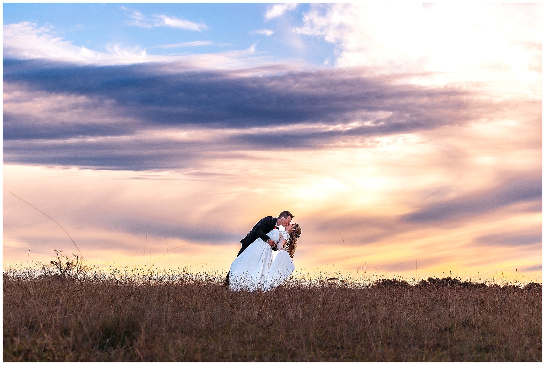 amazing Abbey Rock Gardens reception centre sunset as a groom dips his bride near Uralla NSW