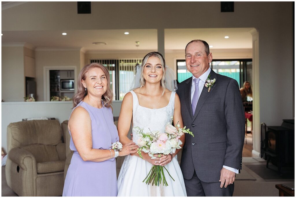 a bride and her parents in the house she grew up in