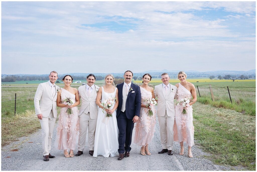 a country road for a bridal party as they walk together