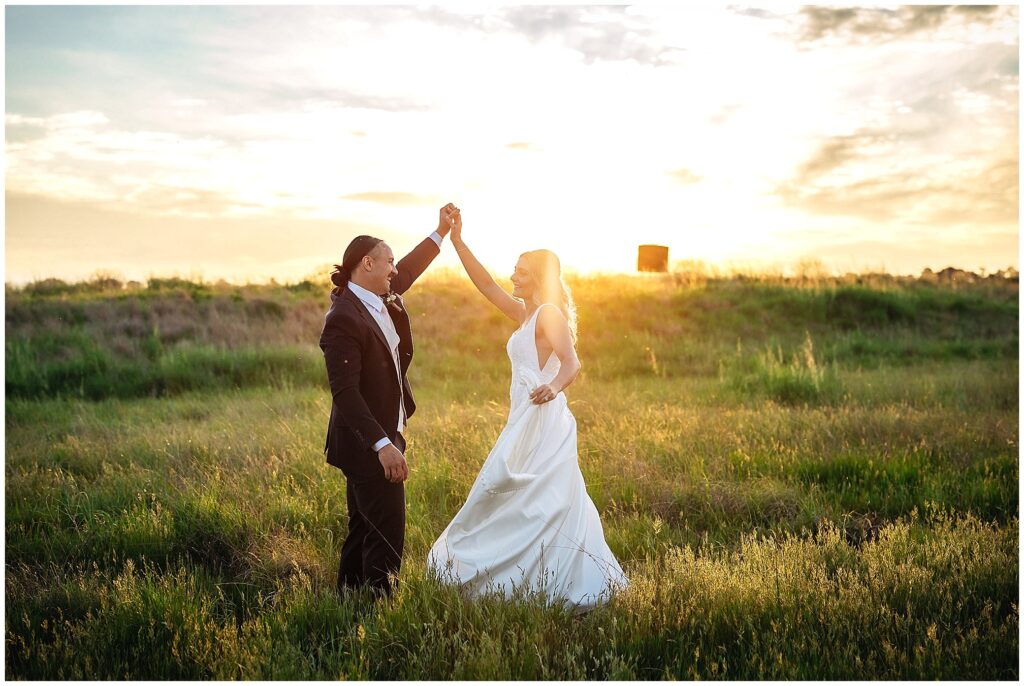 dancing in the long golden grass for a bride and grooma s the sun sets ober Tangarratta
