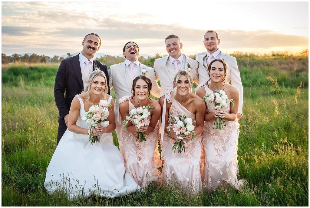a bridal party at Tangarratta Vineyard in the long golden grass as the sunsets over Tangarratta